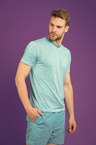 Man with muscular arms confident and strong. Does having muscular body make you more confident. Strong and muscular. Man strict handsome unshaven guy on violet background. Masculinity concept - Foto, Bild