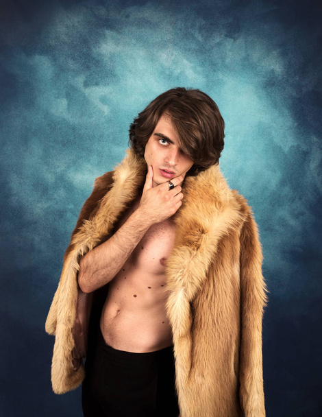Portrait of young  handsome man in fur coat  - Foto, Imagen