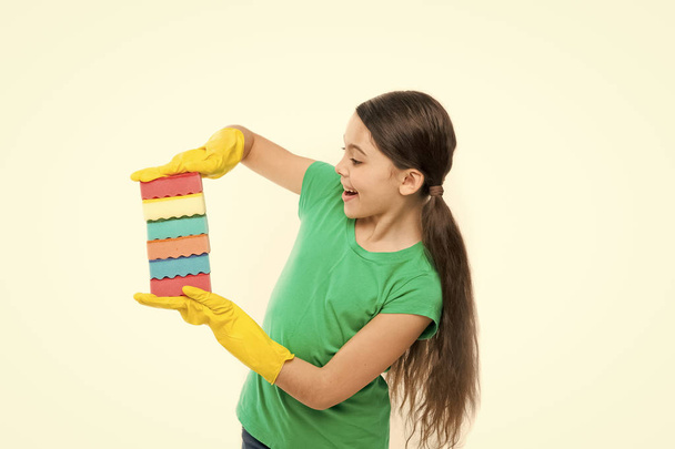 Cleaning supplies. Girl in rubber gloves for cleaning hold many colorful sponges white background. Help clean up. Accessory for cleaning. Housekeeping duties. Wash dishes. Cleaning with sponge - Foto, imagen