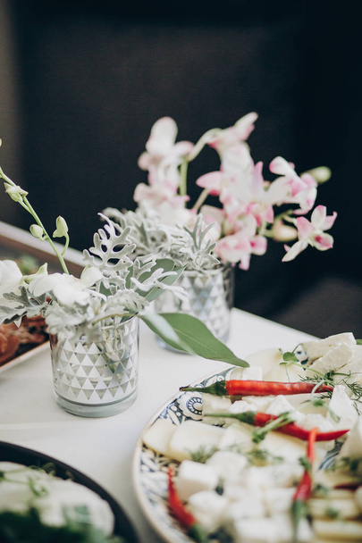 Stylish floral decor on wedding table. White eustoma and orchid  - Φωτογραφία, εικόνα