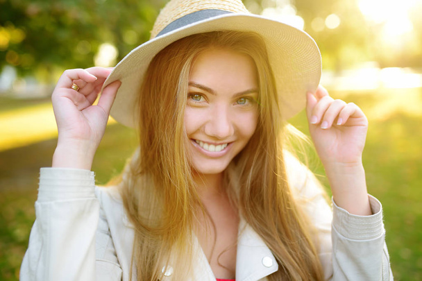 Outdoors portrait of delightful young woman. Charming caucasian girl stroll in sunny day - Foto, Bild