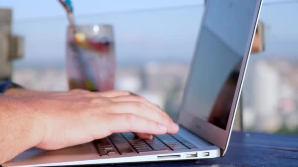 Close up portrait of male hand typing on laptop at outside cafe. - Filmagem, Vídeo