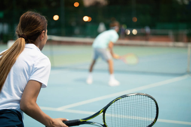 Happy fit people playing tennis together. Sport concept - Photo, image