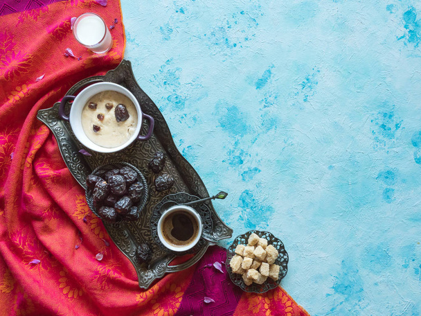 Śniadanie z datami, kawą i zdrową owsianką na niebieskim stole - Zdjęcie, obraz
