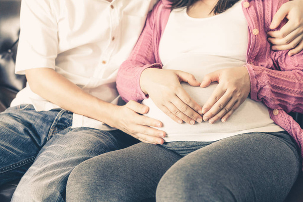Pregnant couple feels love and relax at home. - Photo, Image