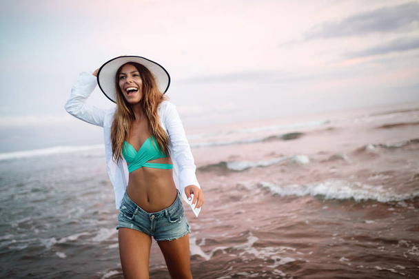 Beautiful woman on the beach at summer vacation - Фото, зображення