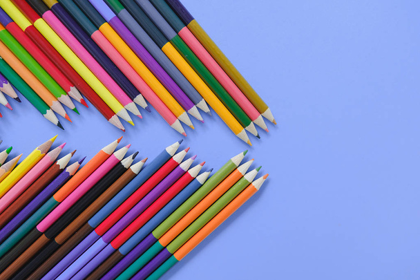 Back to school concept. Closeup images of many color pencils on purple background. Flat lay, top view, copy space. - Foto, immagini