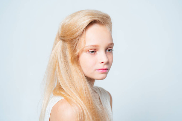 Cool. hair care dyeing. straightening and curling. blonde teen with soft skin. pretty blond girl. skincare and natural makeup. beauty hairdresser salon. healthy long hair with natural color - 写真・画像