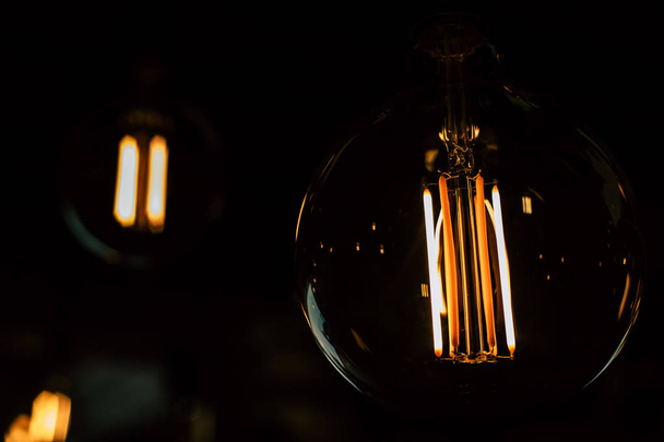 Vintage light bulb closeup with dark background - Fotografie, Obrázek