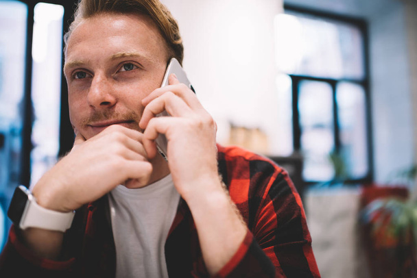 Thoughtful man speaking on phone in cafe - Zdjęcie, obraz
