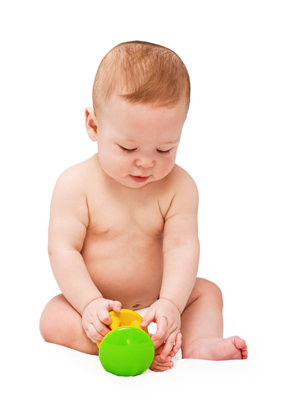 Small baby with toy on the white - Zdjęcie, obraz