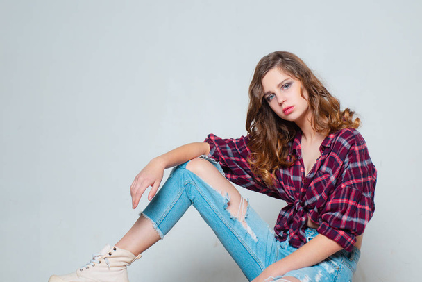 girl trendy look. copy space. beauty and fashion. retro fashion model. teen girl in checkered shirt and jeans. vintage style. denim look. hair fashion. casual child in checkered shirt. youth style - Zdjęcie, obraz