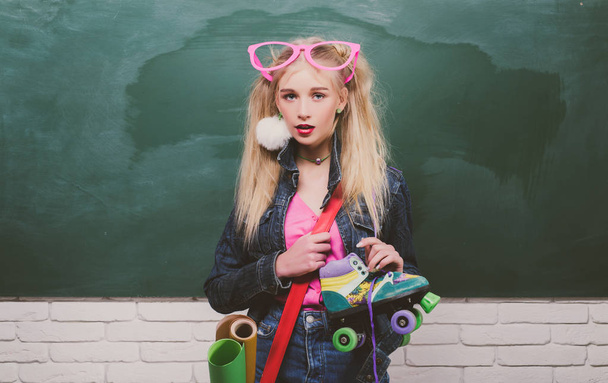 Fashion hipster girl with girl in fashion accessories. Adorable teenager in front of chalkboard. Minimal design fashion Sweet colors. Colorful trendy vibes. School uniform. - Foto, Imagen