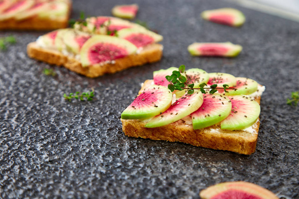 Healthy breakfast toasts from sliced watermelon radish - Photo, Image