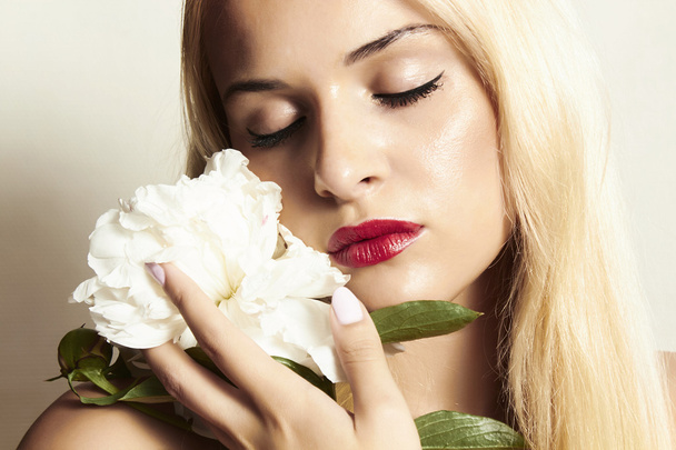 Beautiful blond woman with white flower - Photo, Image