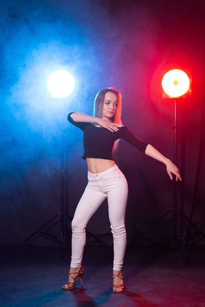Dance and people concept - young sexy woman dancing in the dark and enjoying it - Zdjęcie, obraz