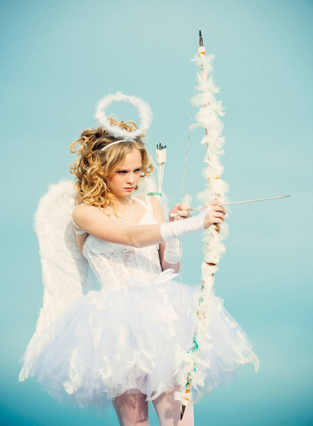 Concept of Valentines Daygirl dressed as an angel on a light background. Little girl with angel wings and halo. Enjoying magic moment. Happy teenage angel girl - Fotografie, Obrázek