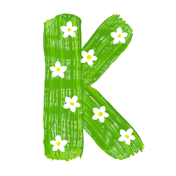 The green letters K drawn by paints with white blossom - Photo, Image