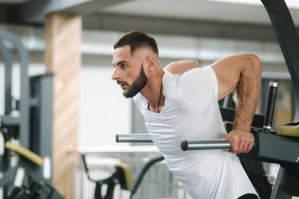 Man warm up in the gym. Handsome bearded man trains - Photo, Image