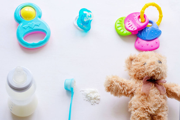 Baby milk powder, baby bottle and children's toys on a light background flat lay - Photo, Image