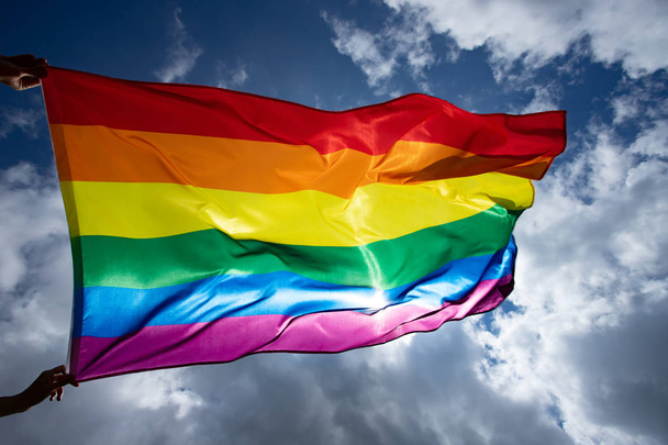 Colorful LGBT flag blows in the breez. - Photo, image