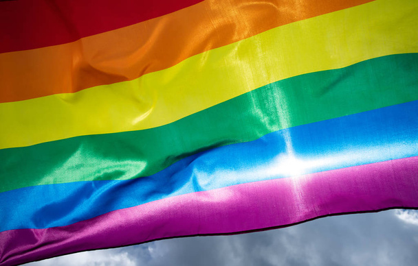 Colorful LGBT flag blows in the breez. - Фото, зображення