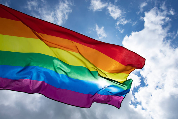 Colorful LGBT flag blows in the breez. - Zdjęcie, obraz