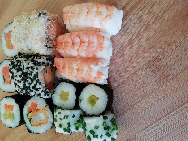 Sushi food. Maki and rolls with tuna, salmon, shrimp, crab, and avocado. Rainbow sushi roll, uramaki, hosomaki, and nigiri. - Photo, Image