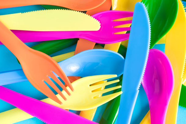 Flat lay of multicolored spoons, knives and forks abstract. - Foto, imagen