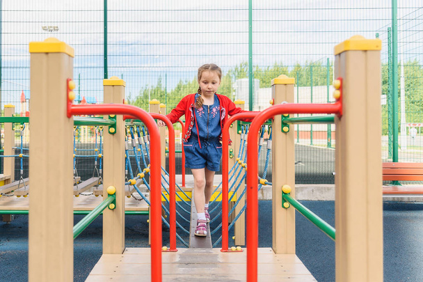Active little girl on playground - Foto, Imagen