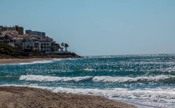 Spanish beach with  Sea waves shining in sun beams - Photo, Image