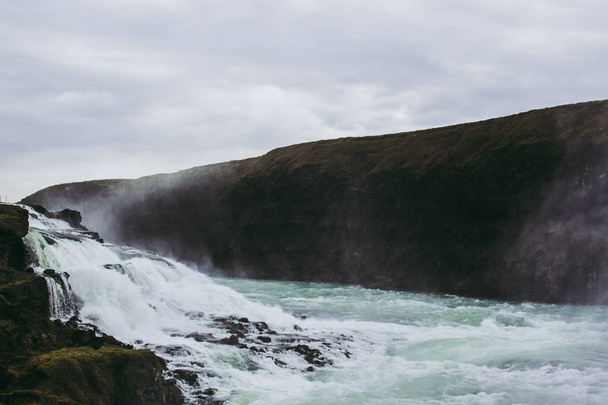 Gullfoss waterfall's cascades on a cold cloudy spring afternoon - Fotografie, Obrázek