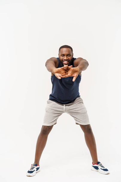 African sport man exercising and stretching on white background - Fotoğraf, Görsel