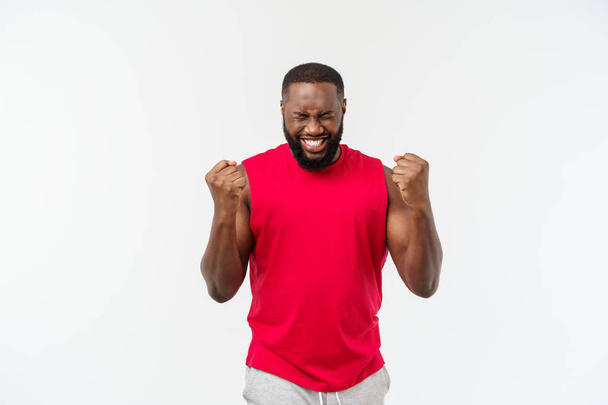 Jeune homme noir africain fitness en tenue de sport acclamant insouciant et excité. Concept de victoire
. - Photo, image