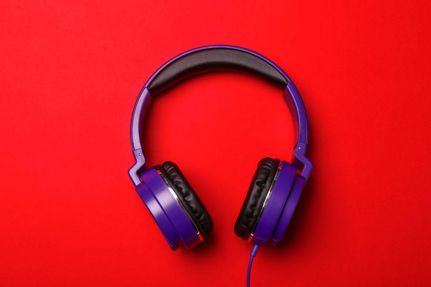 Stylish modern headphones on color background, top view - Photo, Image