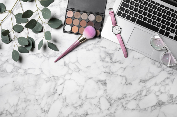 Flat lay composition with laptop and beauty blogger's stuff on marble background, space for text - Foto, imagen