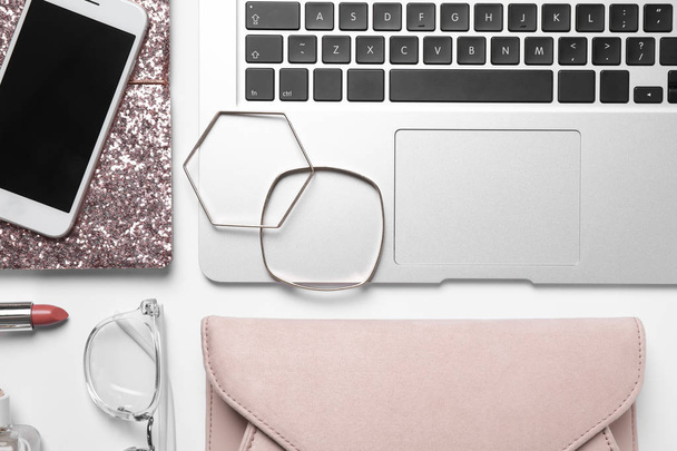 Flat lay composition with laptop, mobile phone and fashion blogger's stuff on white background - Photo, Image