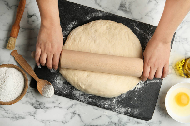 Female baker preparing bread dough at kitchen table, flat lay - Φωτογραφία, εικόνα