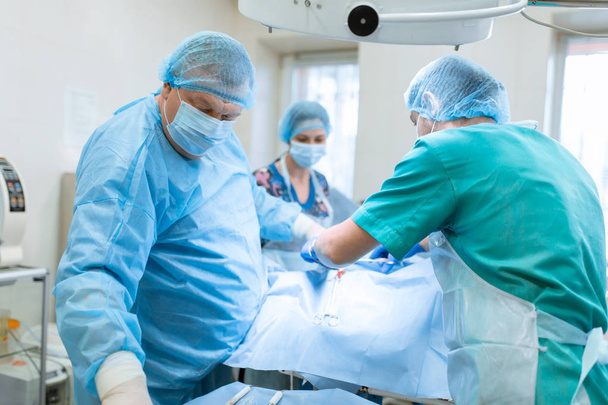 Doświadczony chirurg w masce i sukni działa w sterylnym  - Zdjęcie, obraz