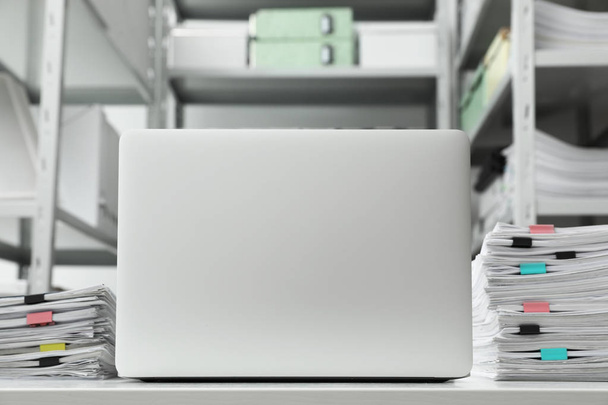 Laptop and documents on desk in office - Φωτογραφία, εικόνα