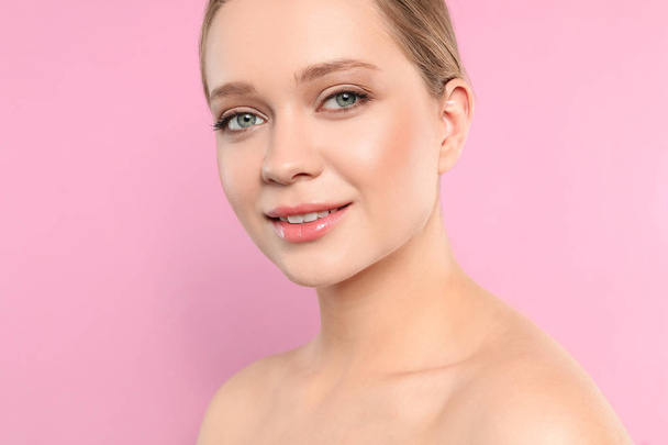 Portrait of young woman with beautiful face on pink background, closeup - Foto, immagini