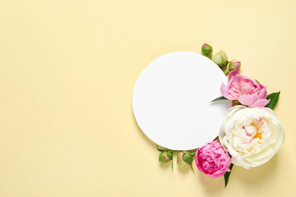Fresh peonies and empty card on color background, flat lay with space for text - Photo, Image