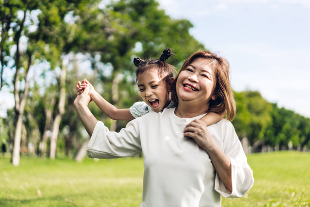 Portrait of happy grandmother and little cute girl enjoy relax t - 写真・画像