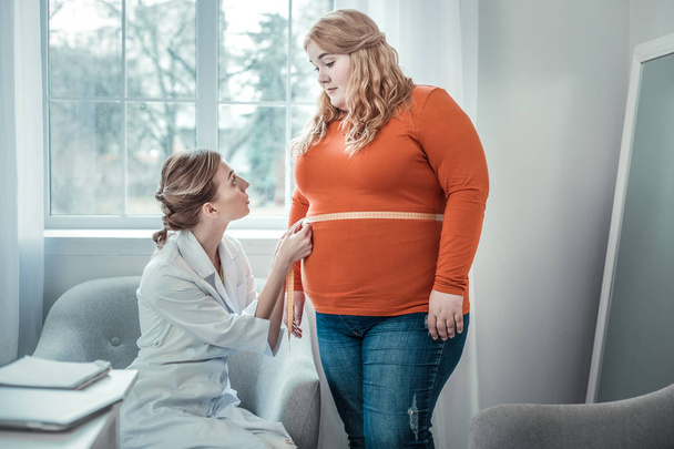 Delighted oversized woman listening to her dietician - Photo, image