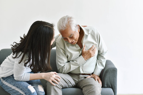 Heart attack disease problem in old man, Elderly asian man with hand on chest gesture, Daughter frighten and worry about her father chest pain symptom, Senior healthcare insurance concept. - Fotó, kép