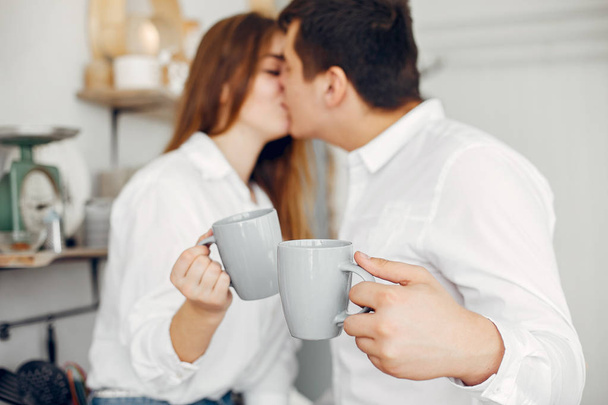 Beautiful couple spend time in a kitchen - Foto, Imagem