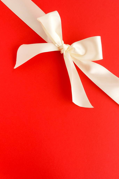 close up view of ribbon on bright red background - Fotó, kép
