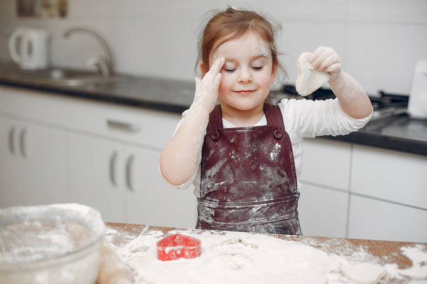 Little girl cook the dough for cookies - Фото, изображение