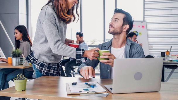 woman designer buy coffee cup to colleague at modern office in m - Foto, Bild