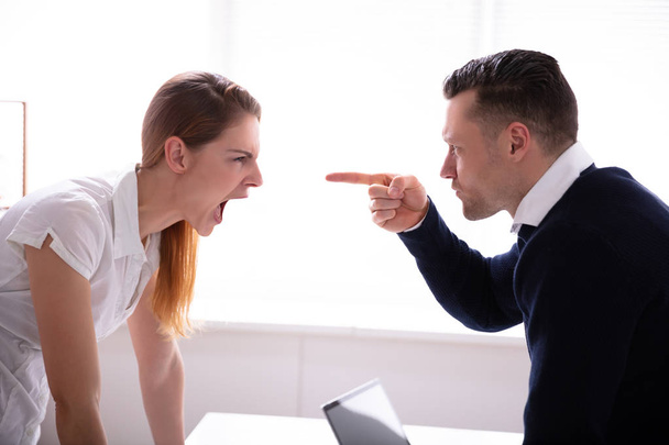 Side View Of Businessman Pointing Finger At Businesswoman While Fighting In Office - Fotoğraf, Görsel